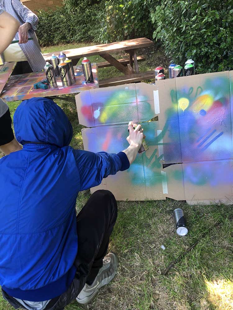 practicing spray paint on card