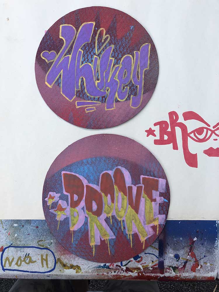 circular graffiti spray painted boards graffiti names drawn with paint pens