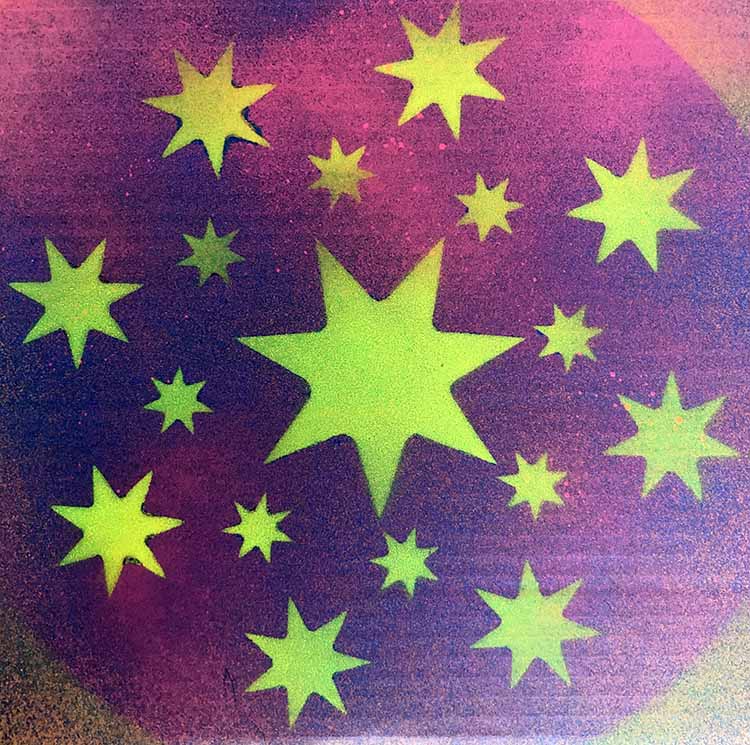 using stencils and spray paint to create a design